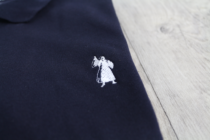 logo on the banner of truth polo shirt