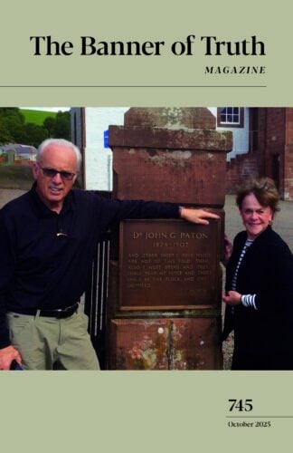 The Banner of Truth Magazine 745 Issue October 2025. The cover is beige with John macArthur and his wife at a monument plaque that says " Dr. John Paton, 1824-1907" and quote.